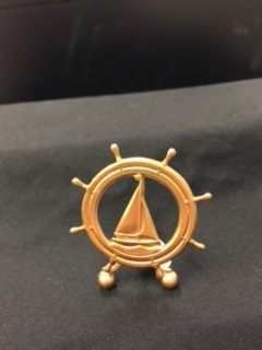 GOLD SAILBOAT IN SHIP WHEEL